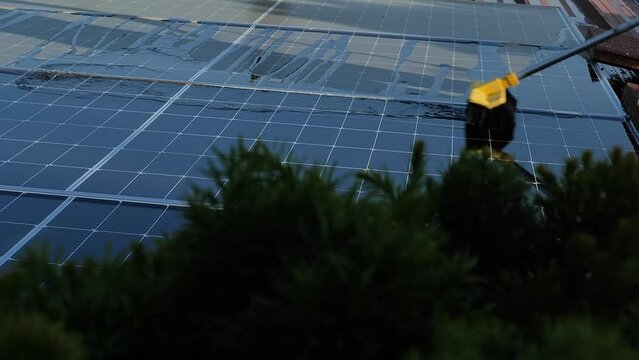 washing solar panels on the roof with water.Solar Panel Efficiency.solar power technology.renewable energy.Alternative natural energy sources. 4k footage