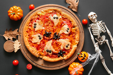 Wooden board with tasty pizza for Halloween celebration on black background