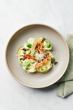 Tortelloni pasta, cream sauce, pancetta, broad beans, pecorino, basil