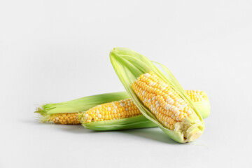 Fresh corn cobs on white background