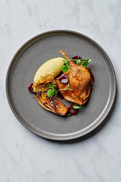 Confit duck leg, creamy mash, caramelised witlof, sour cherry jus, pistachio dusted filo wafer