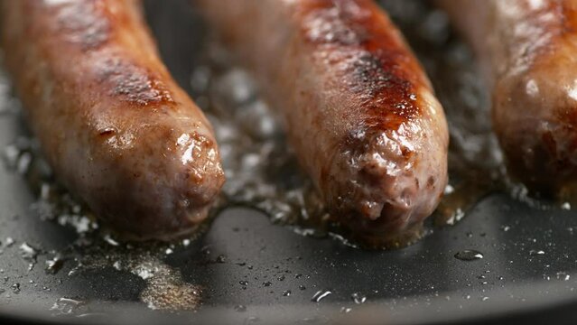 Sausage frying in a pan