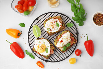 Grid of tasty sandwiches with egg on grey background