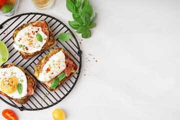 Grid of tasty sandwiches with egg on grey background