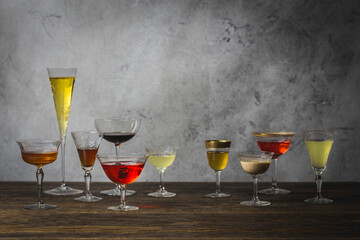 Array of various cocktail, wine and champagne glasses arranged on wood table