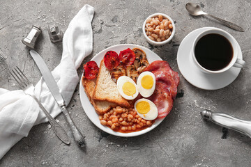 Plate with tasty English breakfast and cup of coffee on grey background