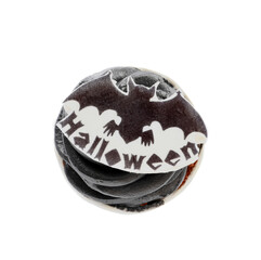 Delicious Halloween cupcake with decor on white background