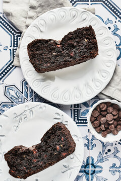 Two Slices of Chocolate Banana Bread on White Plates