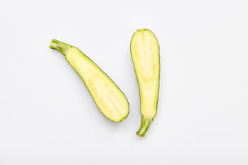 Slices of fresh green zucchini on white background