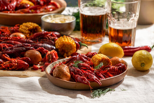 Crawfish party, boiled Louisiana,with corn on the cob, potatoes. Crawfish boiled in Cajun seasonings and herbs.with beer, New Orleans,  Classic Cajun or Creole cuisine