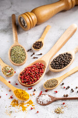 Various spices and seasonings in wooden spoons.