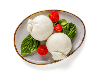 Plate of tasty Burrata cheese with basil and tomatoes on white background