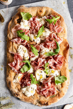 Pizza With Prosciutto, Cheese And Rocket Leaves