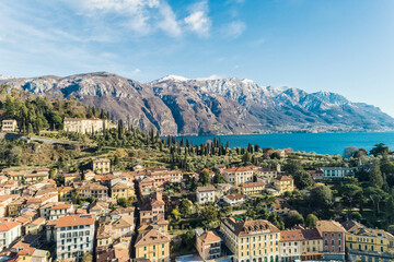 Fototapeta na wymiar Aerial view of Bellagio village on Como lake with blue sky and the Alps in the background, Bellagio, Como, Italy