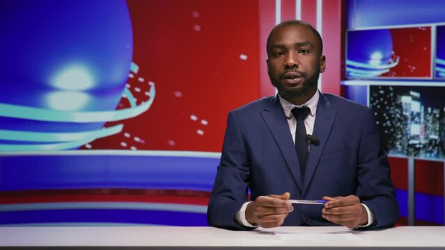 News presenter covering daily topics live on tv program, hosting entertainment and media segment in studio. African american journalist doing reportage of breaking news on global television network.
