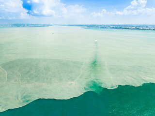 Aerial view of the dirty oily stain and pollution on the coast sea