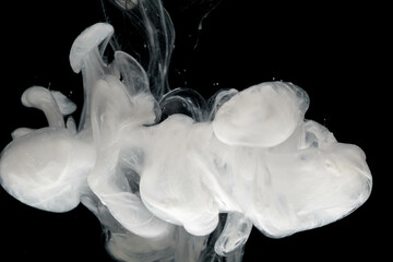 Abstract paint splash isolated on black background. Acrylic ink in water. selective focus.