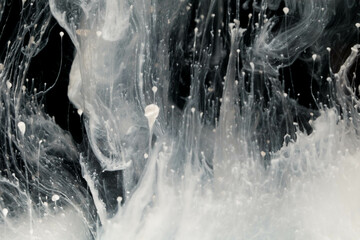 Abstract paint splash isolated on black background. Acrylic ink in water. selective focus.