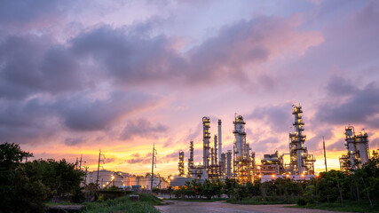 Oil Refinery Plant at sunset. Gas Chemical Equipment Prodiction import export Concept, Crude Oil Refinery Plant Steel Pump Pipe line and Chimney and Cooling tower, Chemical or Petrochemical plant