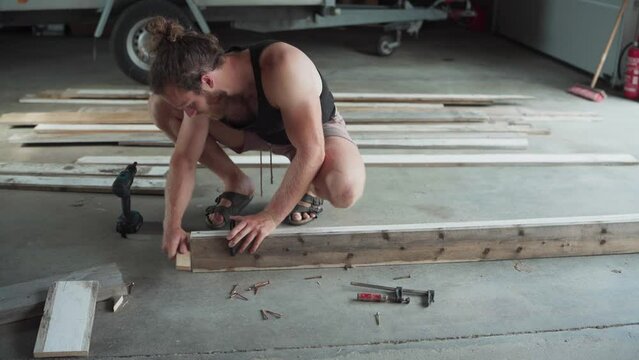 Woodworker Uses F-clamps To Join Wood Planks For Gluing And Drilling. wide