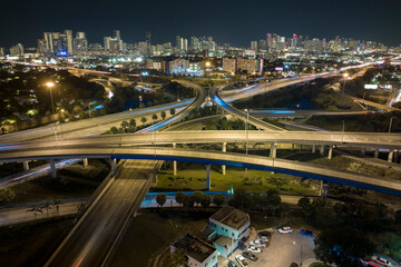 Fototapeta na wymiar Aerial view of american highway junction at night with fast driving vehicles in Miami, Florida. View from above of USA transportation infrastructure