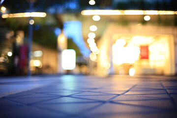 abstract blur outdoor shopping avenue at twilight for background, selective focus on floor pattern