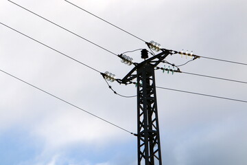 Power electric pole with line wires on insulators.