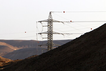 Power electric pole with line wires on insulators.