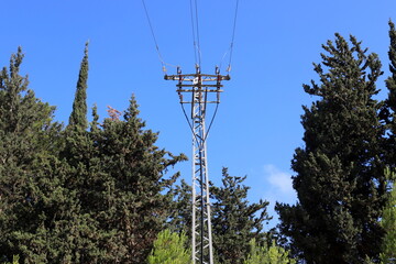 Power electric pole with line wires on insulators.