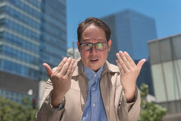 A provoked man with a high temper dares someone to fight him outside during a hot day in the city.