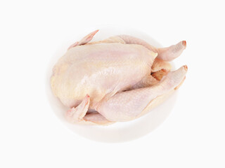 Whole raw chicken on dish isolated on white background.