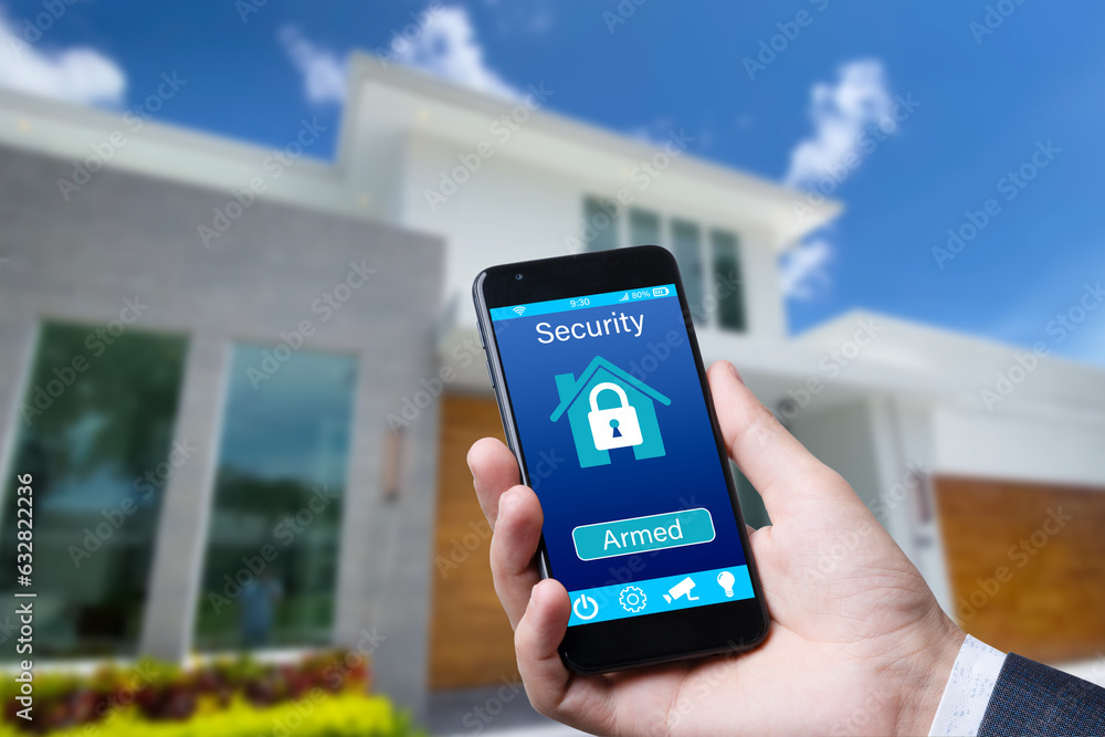 Poster smartphone with home security app in a hand on the building background.