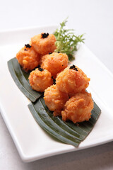 deep fried prawn meat squid ball with salted egg yolk sauce truffle in leaf plate on white background fusion asian halal menu for cafe