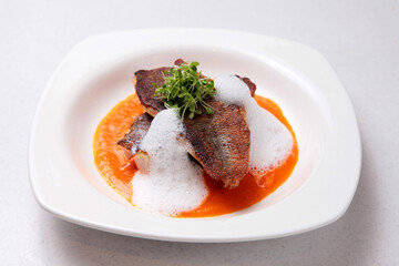 bbq grilled red grouper fish fillet with special bubble cream red spicy sauce in plate fine dining...