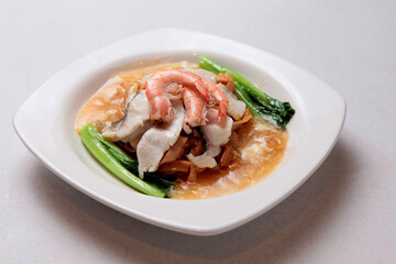 chinese fried hor fun kway teow noodle with prawn fish seafood vegetable in egg thick gravy sauce on white background fusion asian halal food menu for restaurant banquet