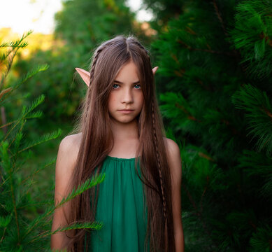 Portrait of a beautiful little elf girl with long hair