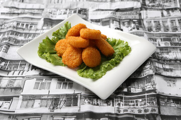 deep fried crispy golden scallops or chicken or fish nugget green salad in plate on grey vintage...