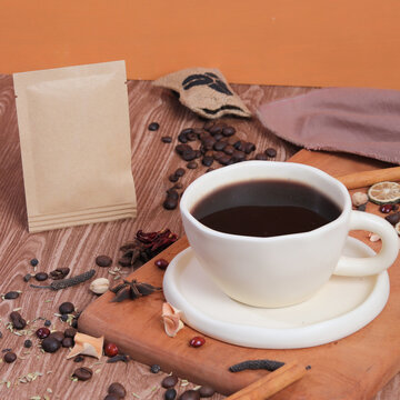 cup of coffee with beans and spices