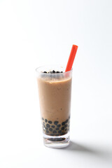 Taiwan popular black boba bubble milk tea with ice in tall glass pearl drink halal food vegan menu in white background with red straw for cafe