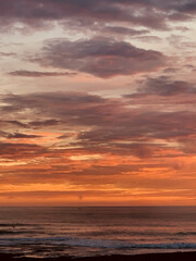 Naklejka na ściany i meble Beautiful dramatic sunset over the sea