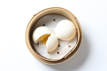 steamed yellow sweet salted egg yolk custard lava bao white round bun skin in bamboo basket dim sum...