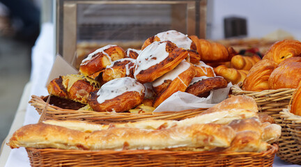 Wicker basket with sweet pastry bread, pistachio swirl and walnut swirl with sugar glaze and nuts...