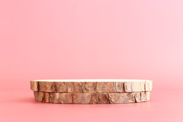 Wooden board over pastel color background. For cosmetics, aesthetics, and objects mockup