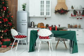 Interior light kitchen and red christmas decor. Preparing lunch at home on the kitchen concept