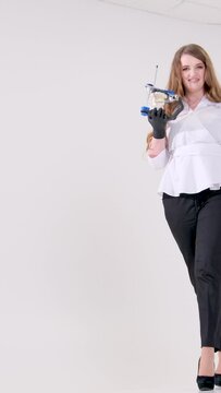 vertical video. White studio lot of space for text female doctor walking space for text ad dental procedures false teeth prosthetics surgery artex system Amanngirrbach dental 