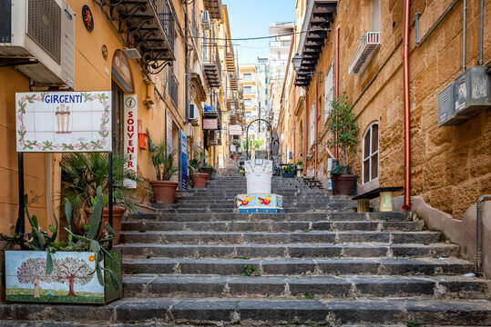 Agrigento, Sicily, Italy - May 19, 2023: Cityscape with old historical buildings, narrow street and medieval steps with colorful ceramic decorations in Agrigento, Sicily