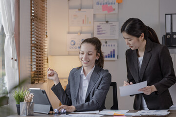 Group of businesswoman team working with analysis financial data visualization tech for marketing strategy, Businesswoman accountant or financial report graph at desk in corporate office.