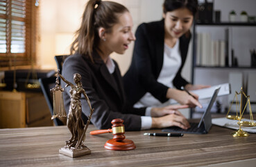 Law and Justice concept, Business woman and lawyers discussing contract papers with brass scale at desk in office, Law, legal judgement.