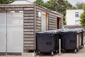 Garbage Can Containers, Trash Bins and Garbage Bins Near Residential Building. Garbage Cans...