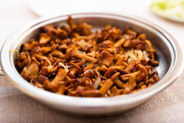 Delicious forest mushrooms chanterelles fried in frying pan